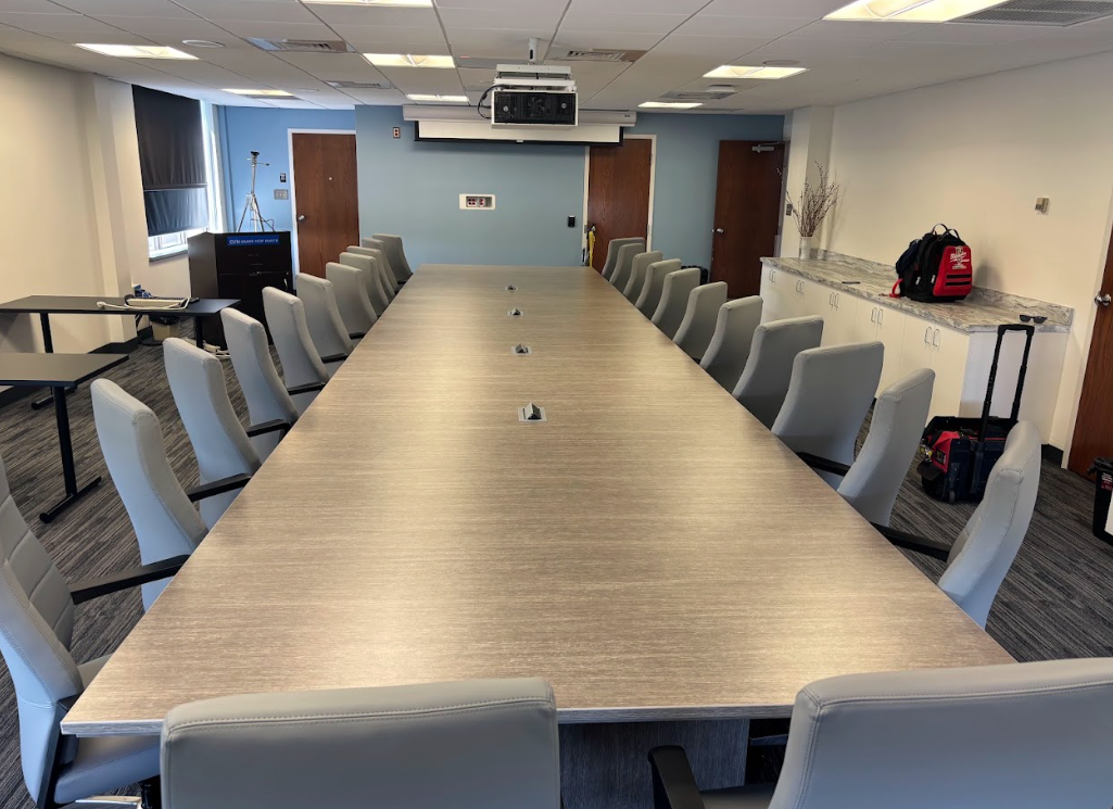 a row of office cubicles with modern ergonomic chairs.